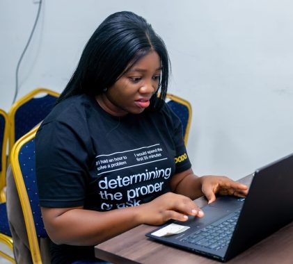 Omowunmi analyzing data during her user research fieldwork.